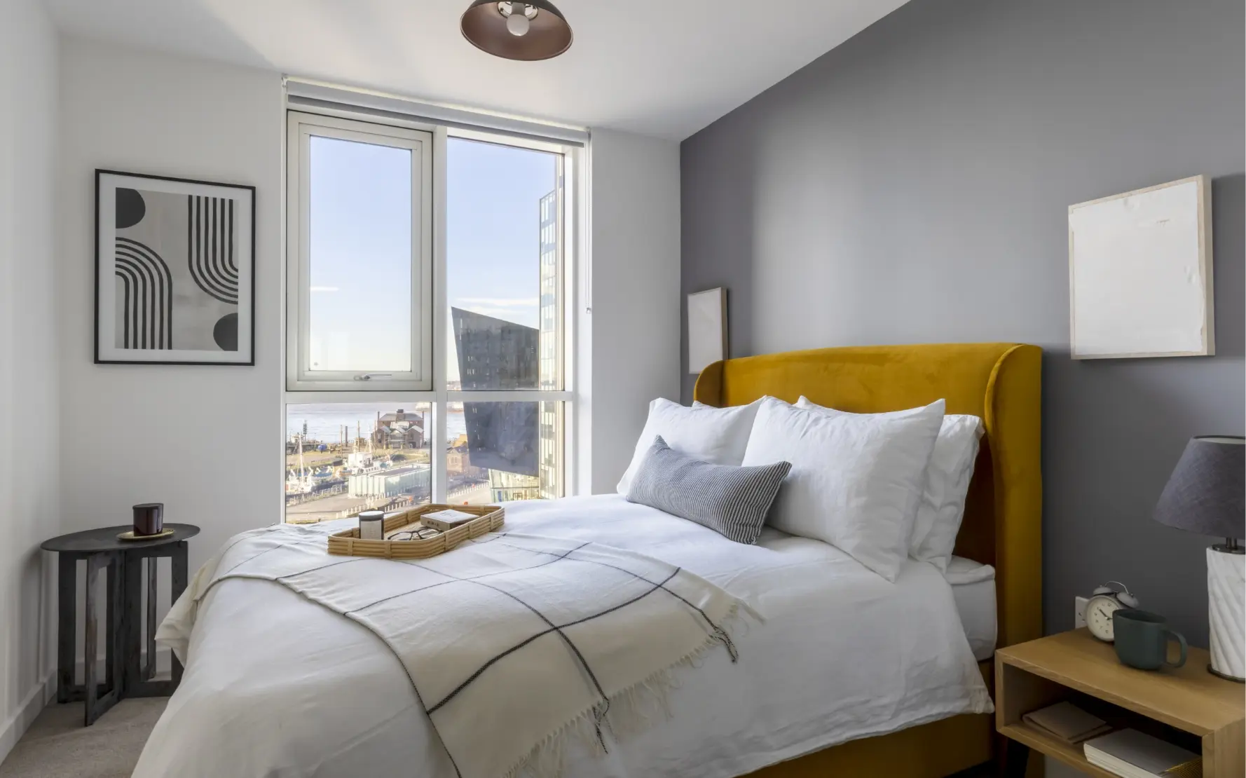 bedroom with double bed, window and artwork on wall