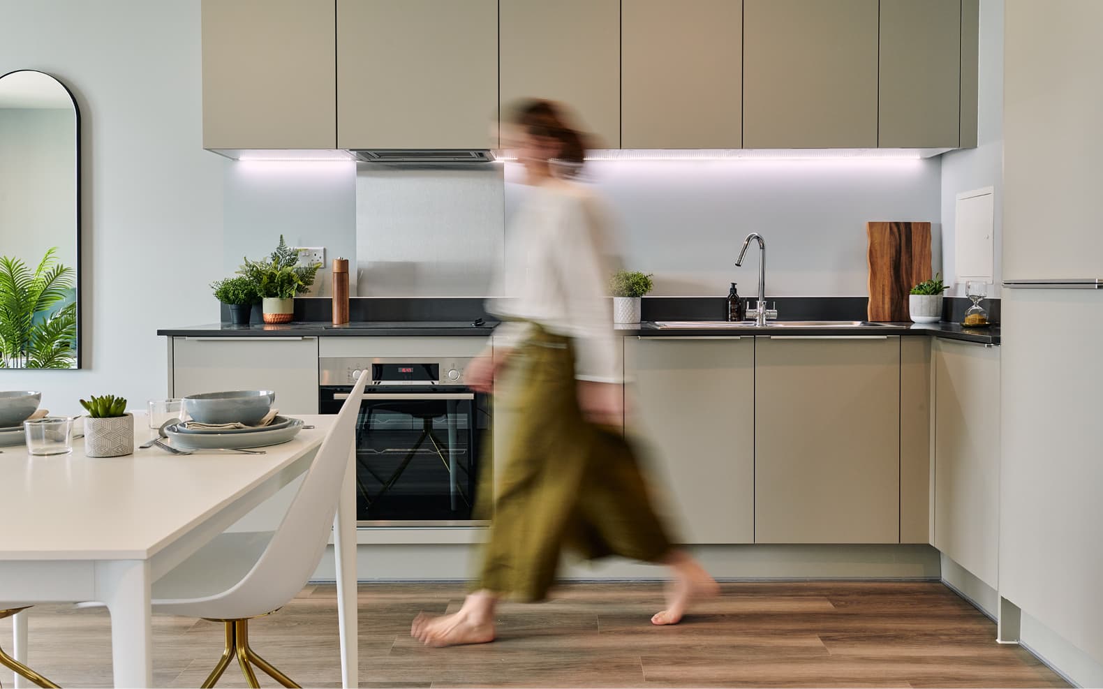 Kitchen with woman walking through