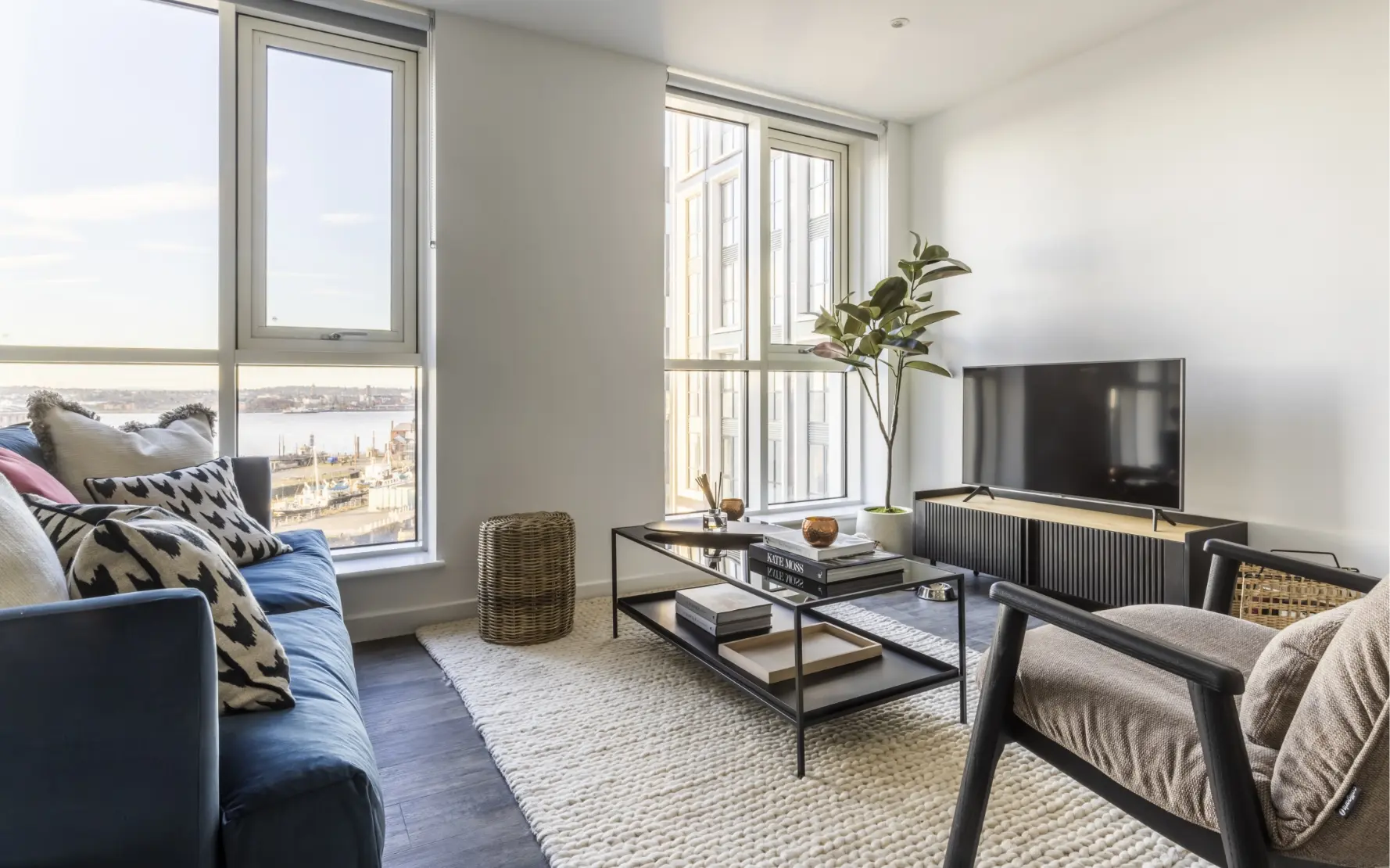 a light filled lounge with couch and coffee table